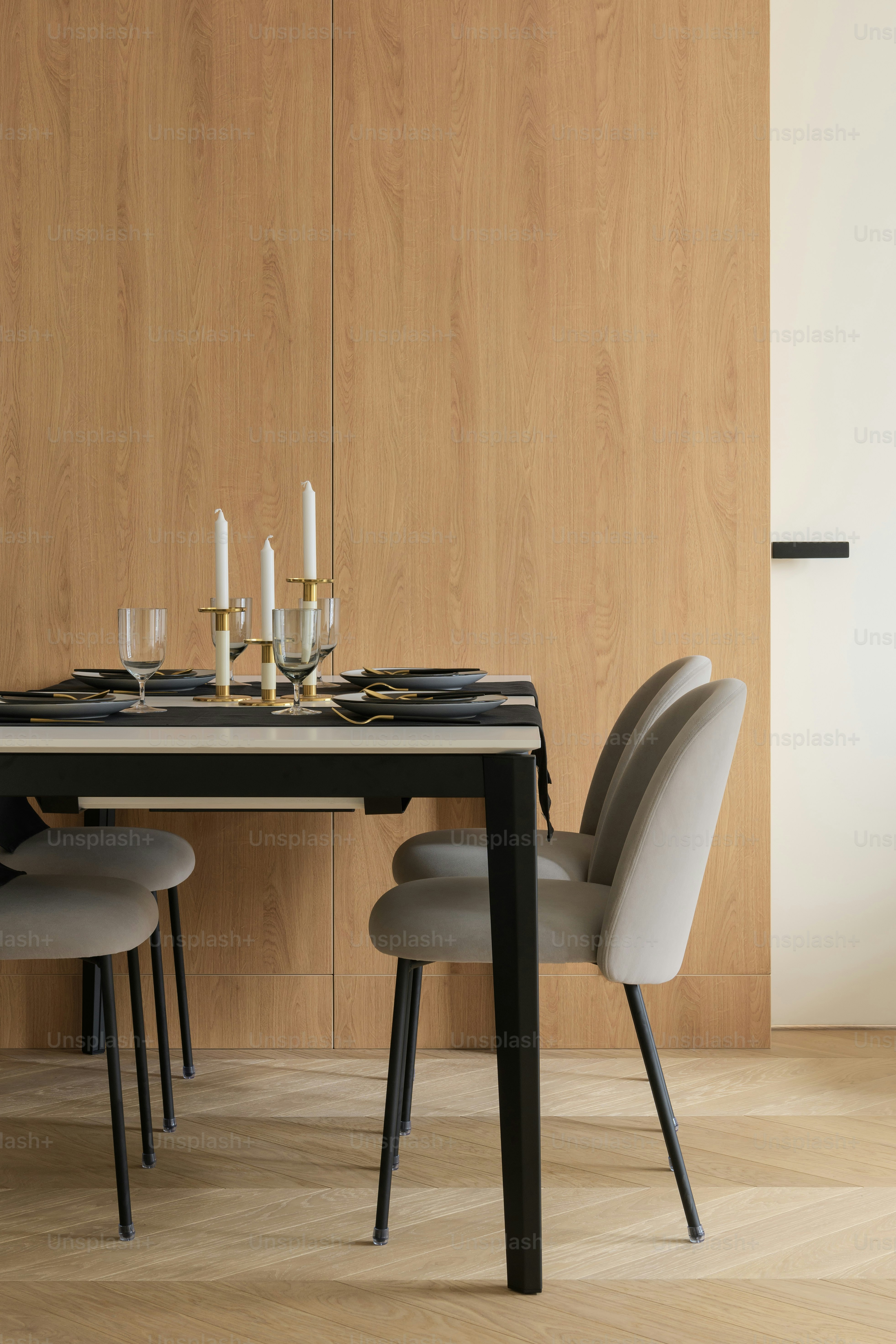 a dining table with a black table and white chairs